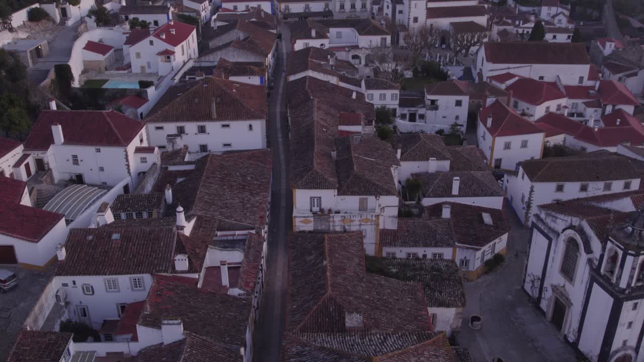 Tilt up shot of Main Street of Castle of &Oacute;bidos Portugal with no people, aerial