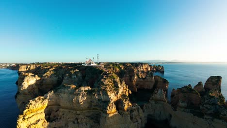 the ponta da piedade lighthouse on the scenic headland near lagos, algarve, portugal. fpv shot