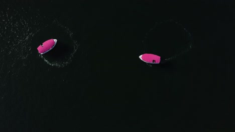 two-pink-party-boats-doing-circles