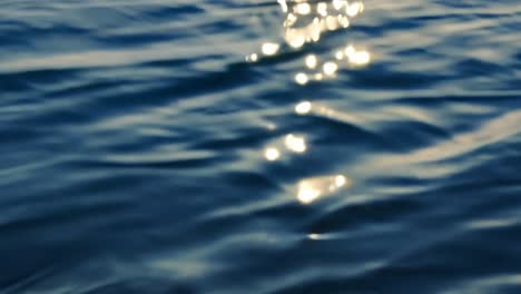 close-up of water ripples with sun reflections