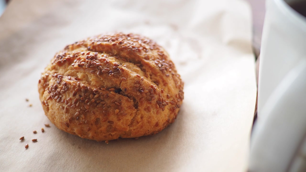 Freshly Baked Sesame Seed Cookie on Parchment Paper with Coffee