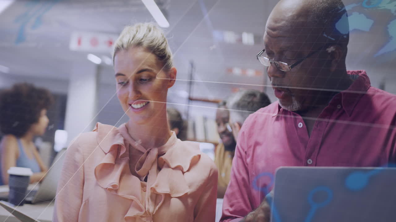 Animation of interface with data processing against diverse man and woman discussing at office