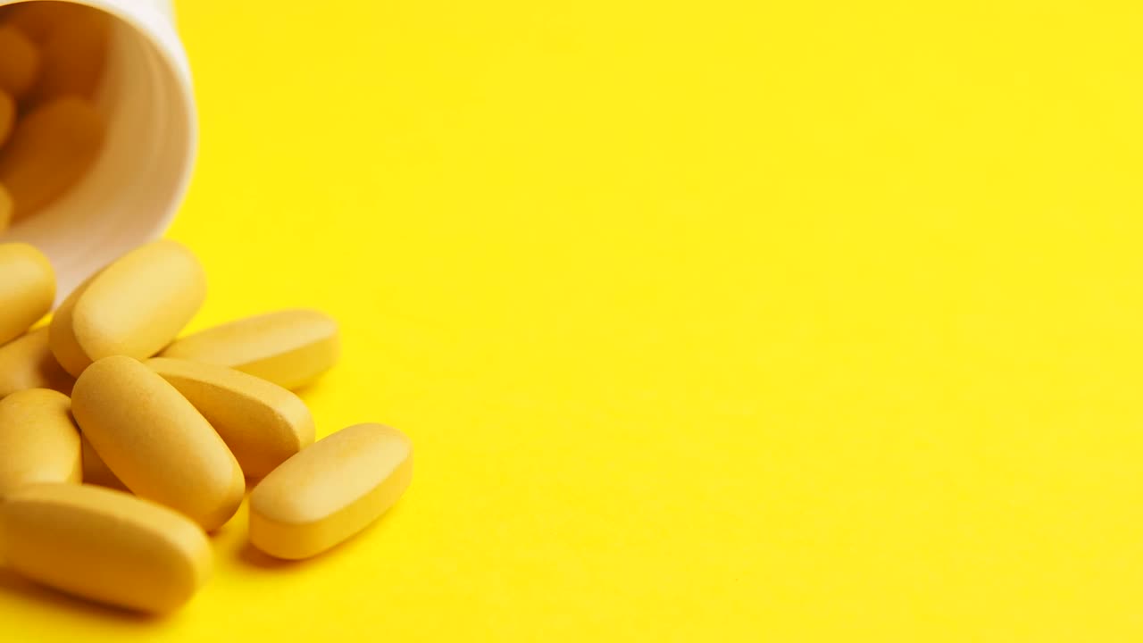 Pills and supplements on yellow background