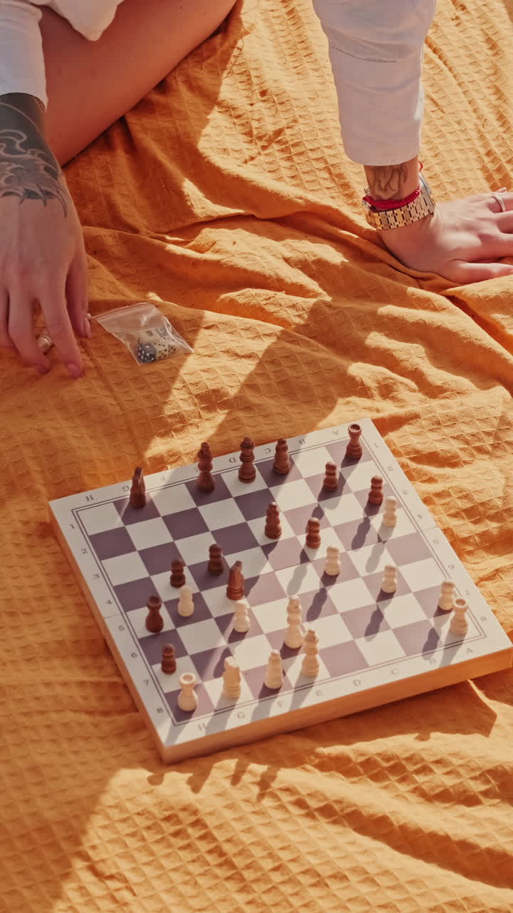 Friends Playing Chess at a Picnic
