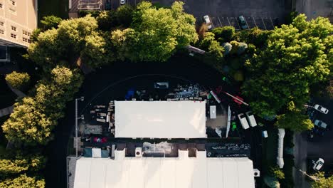 top down cinematic aerial of large wedding event tent on american football field