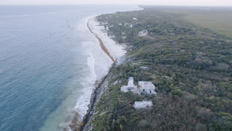 Toma-Aérea-De-Drones-De-La-Costa-En-Tulum-Mexico-Con-Rocas,-Playa-De-Arena-Con-Vista-Al-Cielo-Nublado-Amanecer-4k