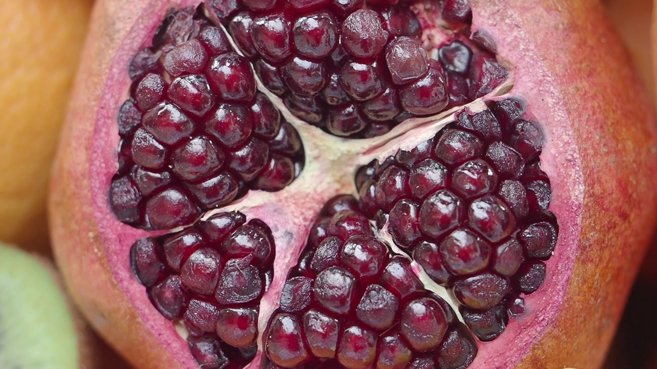 Close Up View of a Freshly Cut Pomegranate with Juicy Red Seeds