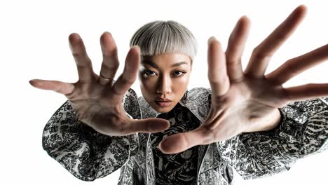 fashion model posing with hands in slow motion on white background