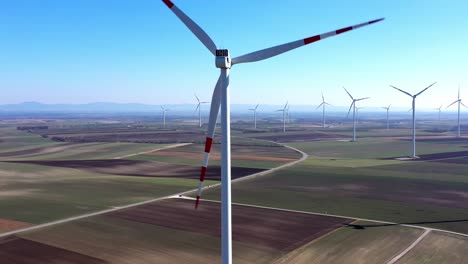 wind turbines and agricultural fields on a summer day - aerial drone shot