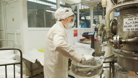 worker packaging powder in a factory