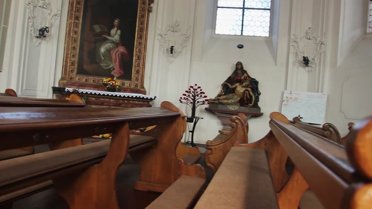 Pews In Church With Statue And Painting