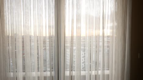 city view through sheer curtains