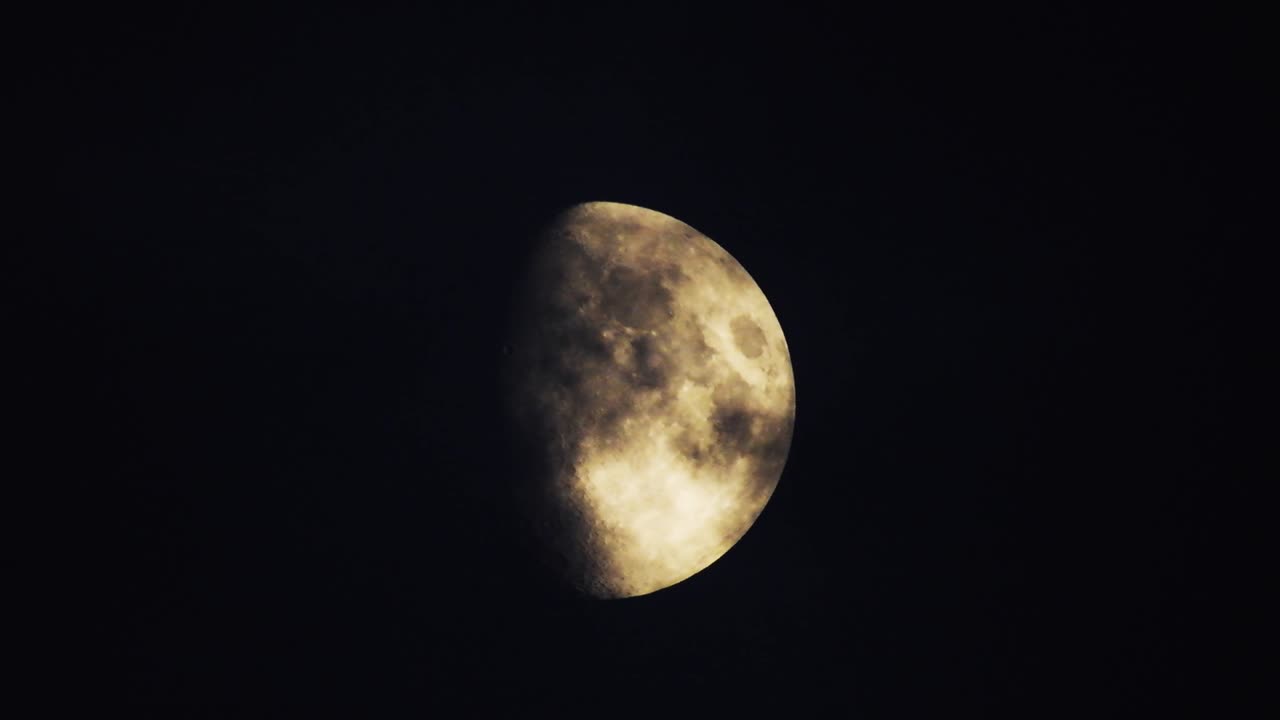 Moon at night with cloud real time. 4k video moon in the black sky.  Clouds passing by moon at night. night sky with cloudy weather