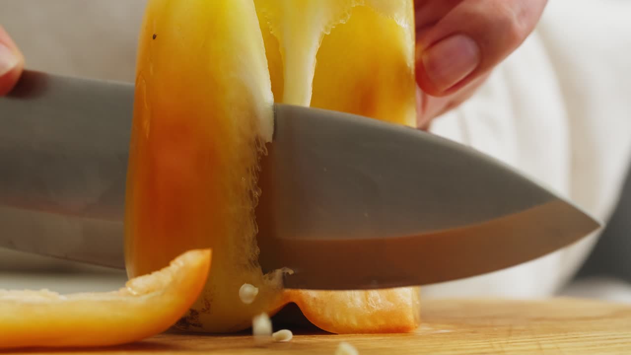 Close-up of Hand Cutting Yellow Bell Pepper and Removing Seeds