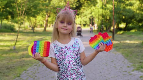 Female-child-girl-with-push-pop-it-bubble-fidget-stress-anxiety-relief-squeeze-sensory-game-toys