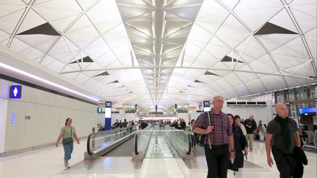 Hong Kong International Airport Terminal Interior with Passengers on Moving Walkways