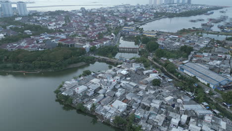 Pluit-Lake-North-Jakarta-Tracking-Back-Over-Slums-Wide-Shot