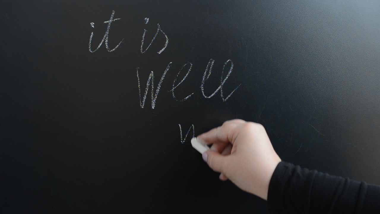 We write the popular phrase on a board. Positive inspirational quote It is well with my soul. We write with chalk on a board