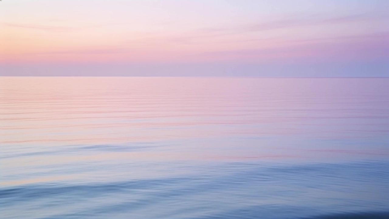 Shifting calm sea with horizon under pastel sky, ripples reflecting shifting dawn light and moving