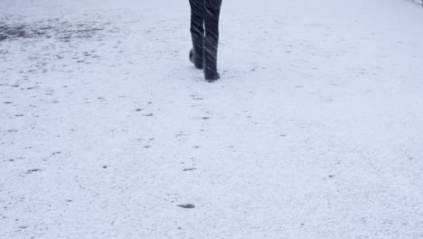 a girl walking and making foot prints in the snow