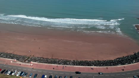 flying towards royal albert drive on scarborough north bay beach in north yorkshire, england