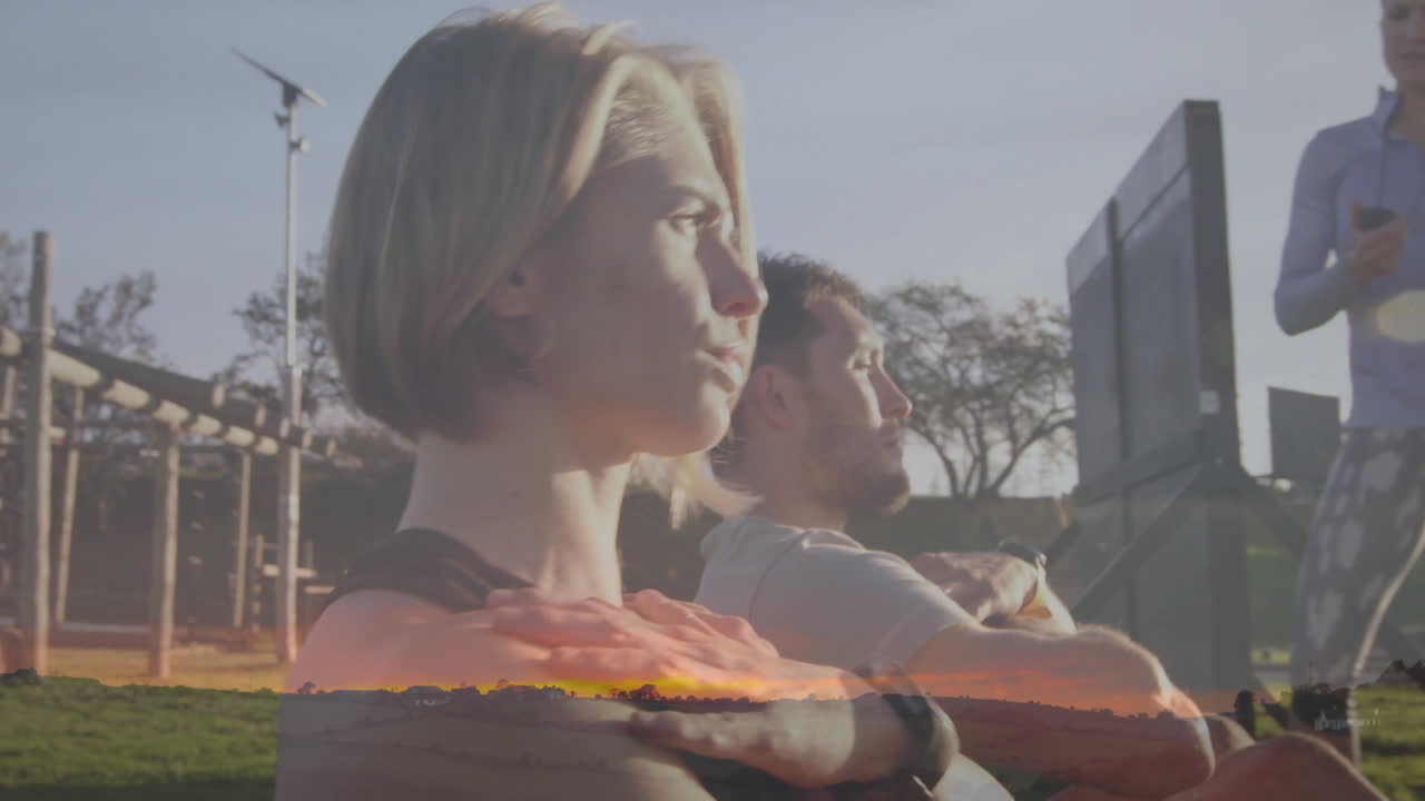 Exercising outdoors, two people with sunset animation overlay in background