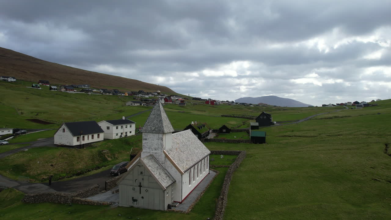 Vi&eth;arei&eth;i church, Faroe Islands: aerial view traveling in over the church of this village in the Faroe Islands