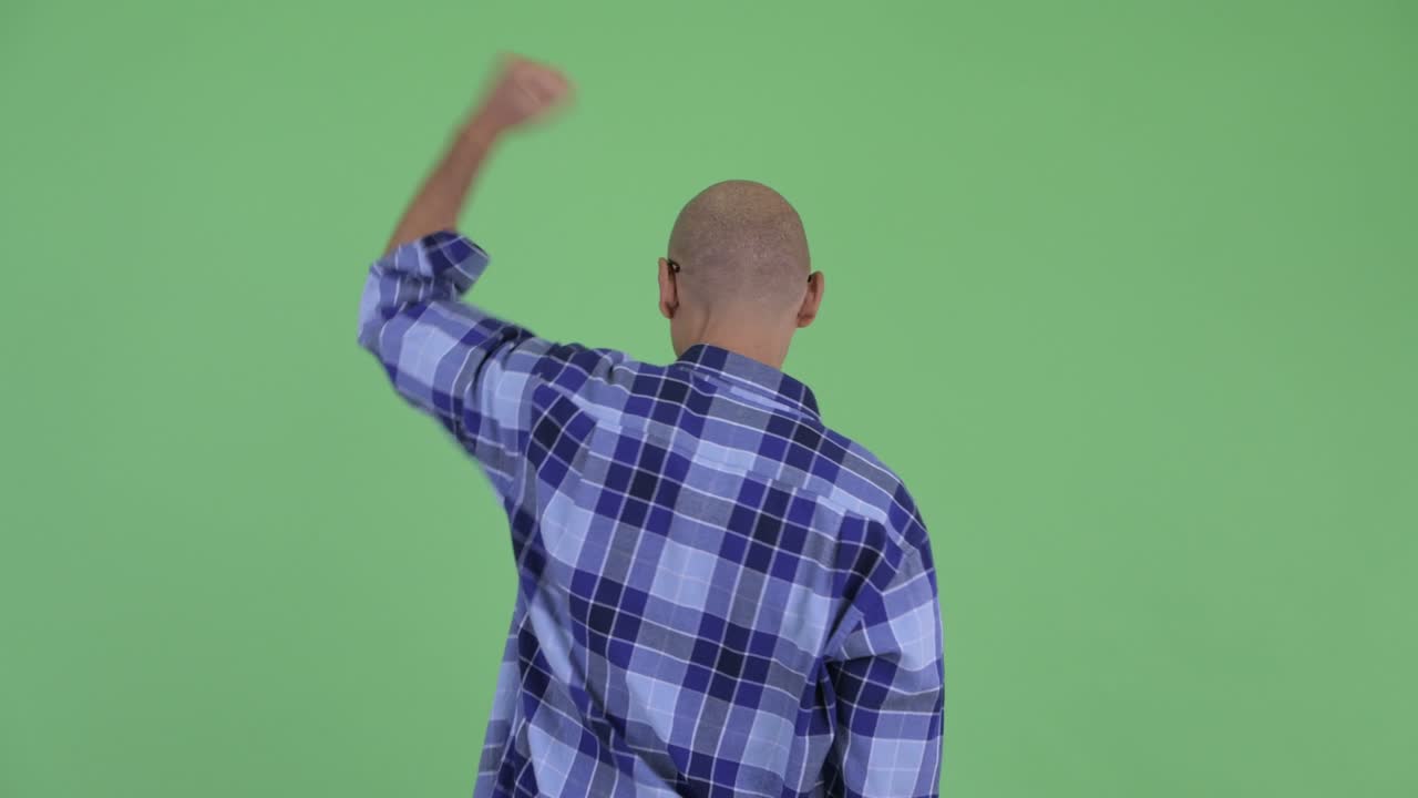 Happy handsome bald hipster man with eyeglasses