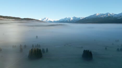 drone shot of piana del cansiglio forest in dolomites mountains in foggy weather