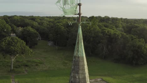 Drone-orbit-of-steeple---weather-vane-of-abandoned-sanatorium-on-the-beach-in-4K