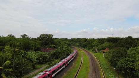 Drone-shot-of-a-train-running-on-rails-in-the-middle-of-countryside
