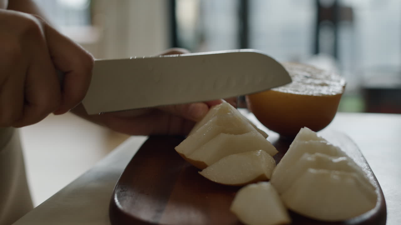Slicing Pears on a Wooden Cutting Board