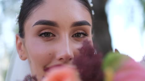beautiful bride in wedding dress holding colorful floral bouquet closeup beautiful bride in wedding dress holding colorful floral bouquet closeup