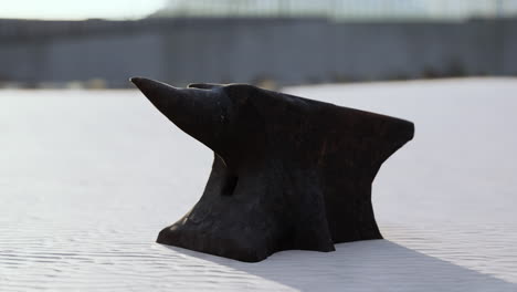 old anvil on a sandy beach