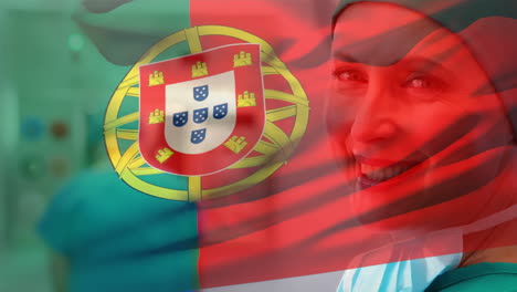 digital composition of portugal flag waving against portrait of female surgeon smiling at hospital