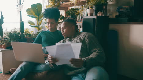 a-couple-going-through-paperwork-while-using