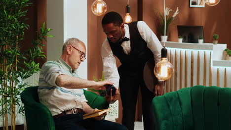 retired man paying for cup of coffee