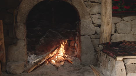 fire on logs in fireplace, heating for cheese making process, chobareti georgia