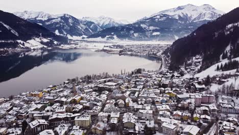 aerial view of zell am see in austria, winter wonderland, pull back, day