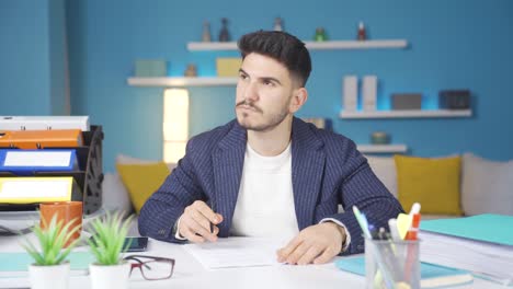 Young-businessman-reading-and-signing-documents.