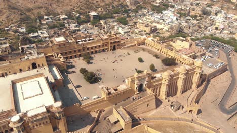 Top-view-over-main-entrance-of-Amber-fort,-ovelooking-Suraj-Pol-Jaipur,-Rajasthan,-India---Aerial-Orbit-wide-shot