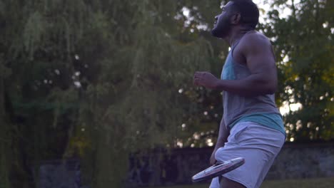 embarrassed black make returns a bad tennis ball to his opponent during a casual evening game
