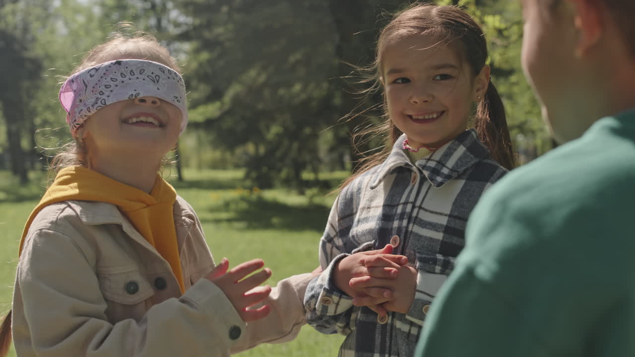 Children Playing Blindfolded Game Outdoors