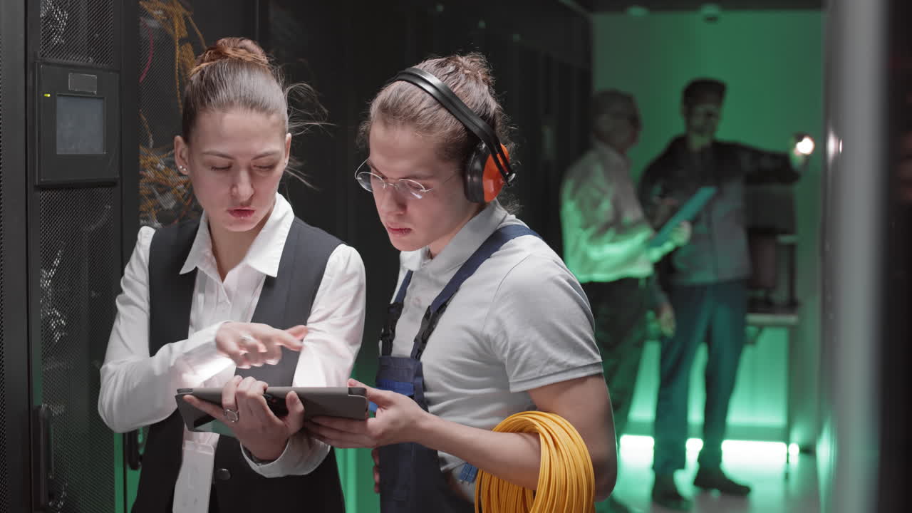 Technicians Inspecting Servers in Data Center