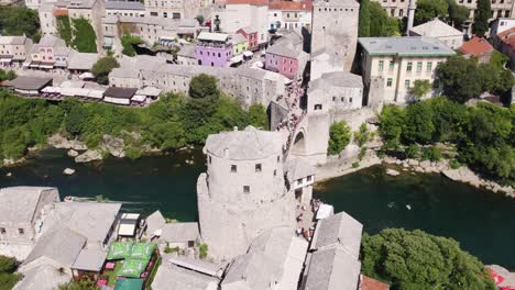 aerial overhead view of mostar bridge with river neretva running underneath