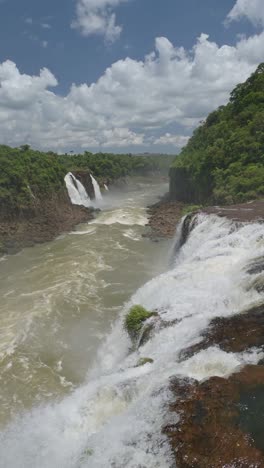 vertical iguazu falls waterfalls scenery for social media instagram reels and tiktok of iguacu falls beautiful landscape of argentina and brazil sides in elevated aerial view on sunny day