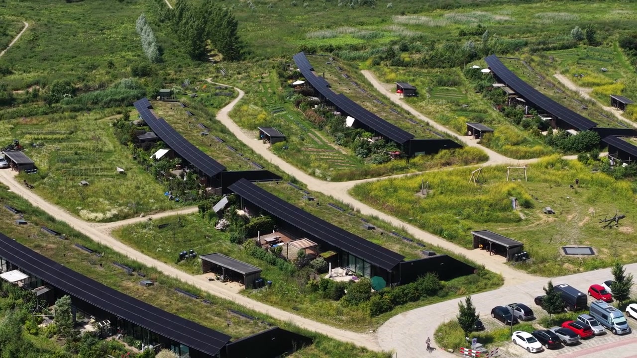 Aerial view of Ecovillage in Almere, the Netherlands, showing sustainable homes, biodiverse landscaping, nature inclusive architecture and climate adaptive residential design.