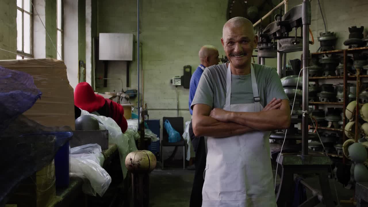 Mixed race men working at a hat factory