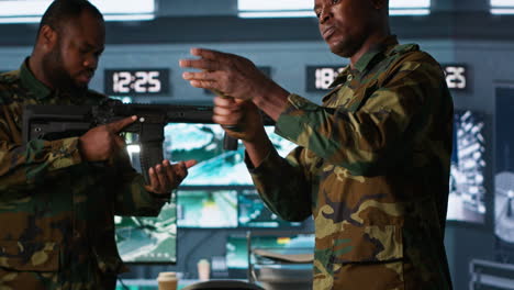 Close-up-of-military-unit-in-command-center-packing-handgun