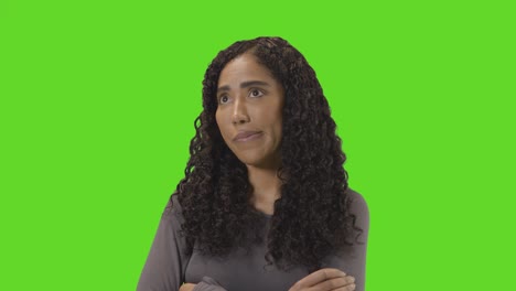 frustrated woman looking at mobile phone against green screen